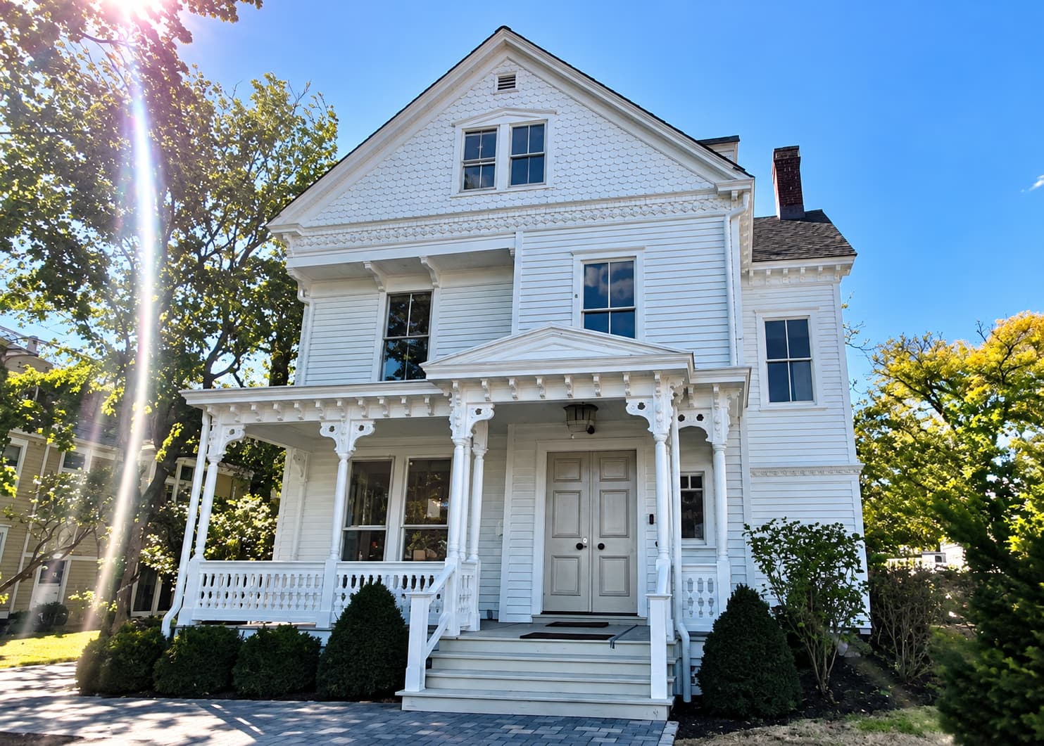 Charming Greenwich home showing the roofline where the built-in Yankee gutters meet the new 5-inch K-style gutters.