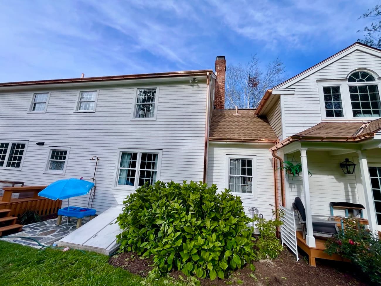 Half-round copper gutters and downspouts trace the edge lines of this beautiful home.